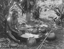 Man pounding poi.